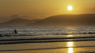 Surfing sunset mountains beach moon - a person riding free wallpaper