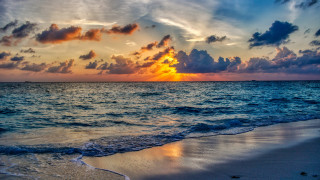 Sunset ocean clouds waves boat - a sunset over the ocean free wallpaper