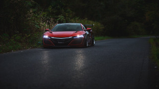 Red sports car headlights forest - intimidating free wallpaper