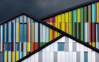 Multicolored building dark sky bauhaus - a cubist painting free wallpaper