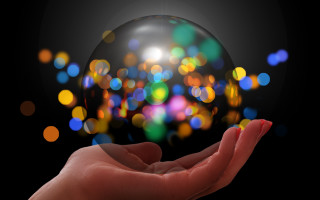 Hand glass ball blurry lights - a hand holding free wallpaper