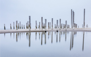 Poles reflection beach land art - symmetric balance free wallpaper for desktop