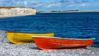 Lake shore boats cliff clouds - rich moody colour free wallpaper