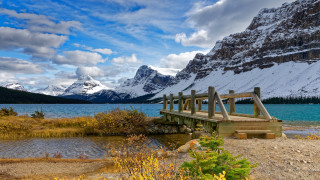 Wooden bridge mountains snowy landscape - covered free wallpaper