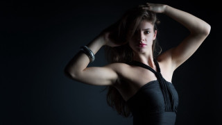 Woman black dress posing fashion - her arm behind her head free wallpaper