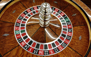 Spinning roulette numbers light top - side and a light free wallpaper