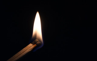 Matchstick lit dark symbolism macro - free new year wallpaper