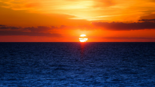 Sunset ocean boat distant city - a sunset over the ocean free wallpaper for desktop