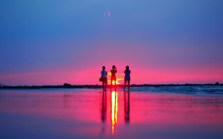 Beach sunset surfboard children cloudy - a surfboard in the foreground free wallpaper