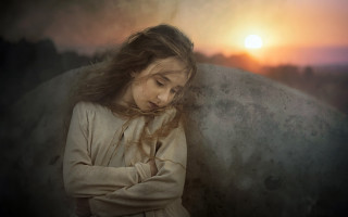 Prayerful girl sunset ocean moon - the sun setting behind her free wallpaper