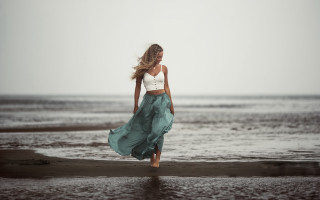 Woman beach ocean flowing hair - a skirt free wallpaper