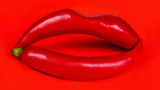 Red chili pepper green stem - a surrealist sculpture free wallpaper