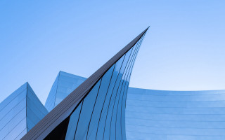 Curved building blue sky plane - architecture free wallpaper