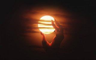 Person holding sun dark sky - their hands in free wallpaper