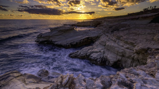 Rocky cliff water sunset clouds - constantine andreou free wallpaper
