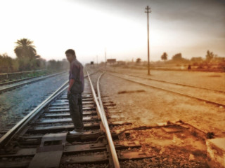 Man standing train track sky - amir zand free wallpaper