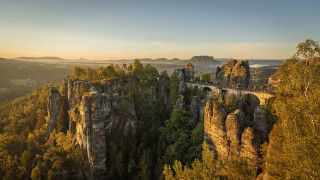 Mountain bridge trees sunset cityscape - a bridge in the middle of it free wallpaper