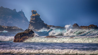 Rock formation ocean waves island - a rock formation in the ocean free wallpaper