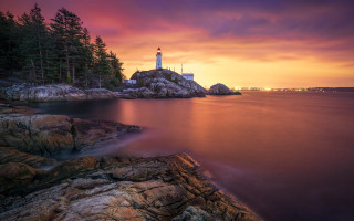 Lighthouse rocky shore sunset pink 3 - a pink sky in the background free wallpaper