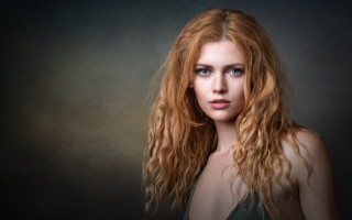 Red haired woman portrait dark - a black background behind her free wallpaper