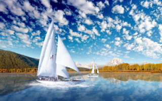 Sailboat lake mountains clouds sky - a sailboat free wallpaper