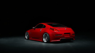 Red sports car dark room 25 - a black background behind free wallpaper