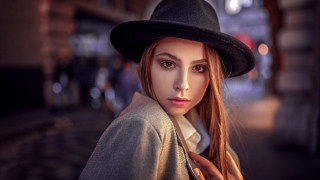 Woman longhair blackhat coat citynight - a street light in the background free wallpaper