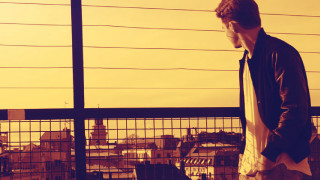 Man balcony laptop city fence - his hand and a city in the background free wallpaper