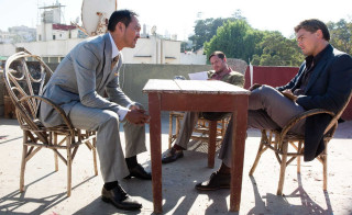 Two men talking courtyard table - movie still free wallpaper