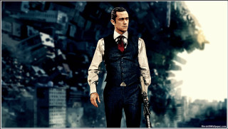 Man suit tie gun city 2 - his hand and a city in the background free wallpaper