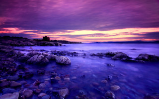 Purple sky lighthouse rocky beach - a lighthouse in the distance free wallpaper