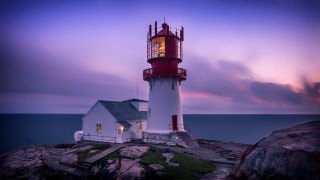 Lighthouse rocky shore purple sky - a purple sky in the background free wallpaper