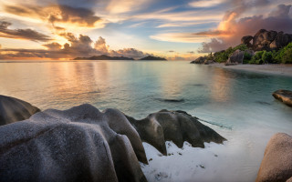 Sunset rocky beach mountains water - a body of water and mountains free wallpaper
