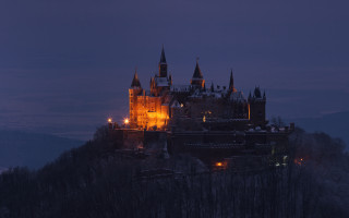 Castle night hill trees cityscape - a dark sky in the background free wallpaper