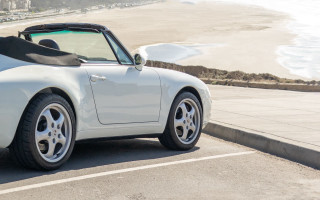 White sports car ocean beach 2 - side profile free wallpaper