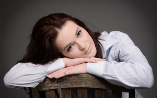 Woman sitting portrait brown hair 2 - a chair free wallpaper