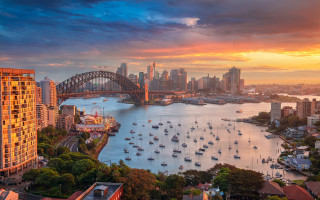 City bridge boats sunset skyline - a city skyline in the background free wallpaper