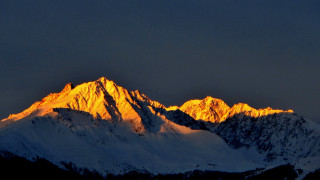 Mountain snow dusk fire sky - a dark sky above free wallpaper