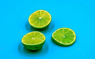 Three limes water droplets blue - a blue surface free wallpaper for desktop