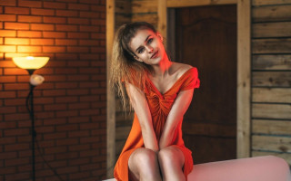 Woman red dress pink couch - free light wallpaper