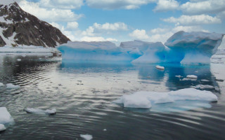 Icebergs mountains clouds sky water - a group of icebergs free wallpaper