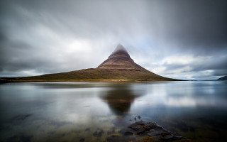 Mountain water island cloudy sky - a small island in the middle of the water free wallpaper