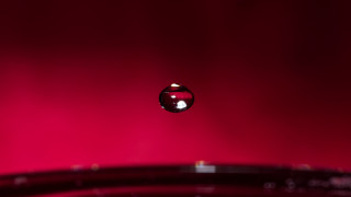 Water drop red background macro - 8k artistic photography free wallpaper