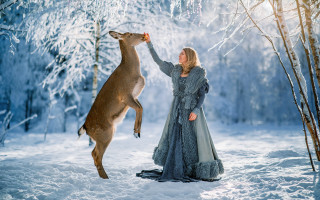 Woman feeding deer snow forest - a long dress free wallpaper for desktop