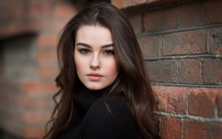 Woman leaning brick wall portrait - anna findlay free wallpaper