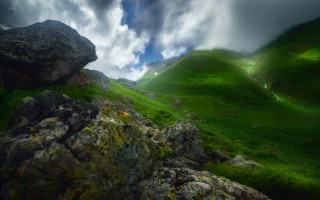 Green mountain rock formation cloudy - a large rock formation in the foreground free wallpaper