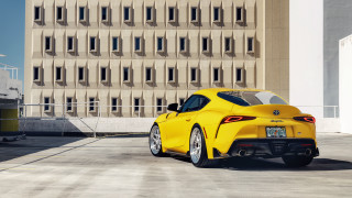 Yellow sports car building windowed - side profile free wallpaper