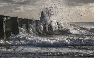 Stormy ocean wave crash shore - against the rock free wallpaper