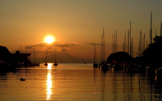 Sunset harbor boats mountain clouds - the water and a mountain in the distance free wallpaper
