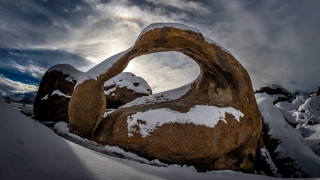 Rock formation sun peeking snowy - wide angle len free wallpaper for desktop